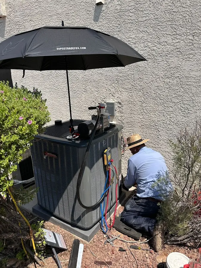 HVAC technician performing outdoor AC maintenance in Woodbury
